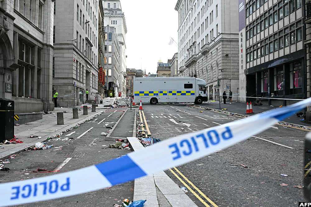Police officers stand at a cordon on in Water Street in Liverpool, north-west England on May 27, 2025, after a car ploughed into crowds gathered to watch an open-top bus victory parade for Liverpool's Premier League trophy parade. (Credit: AFP)