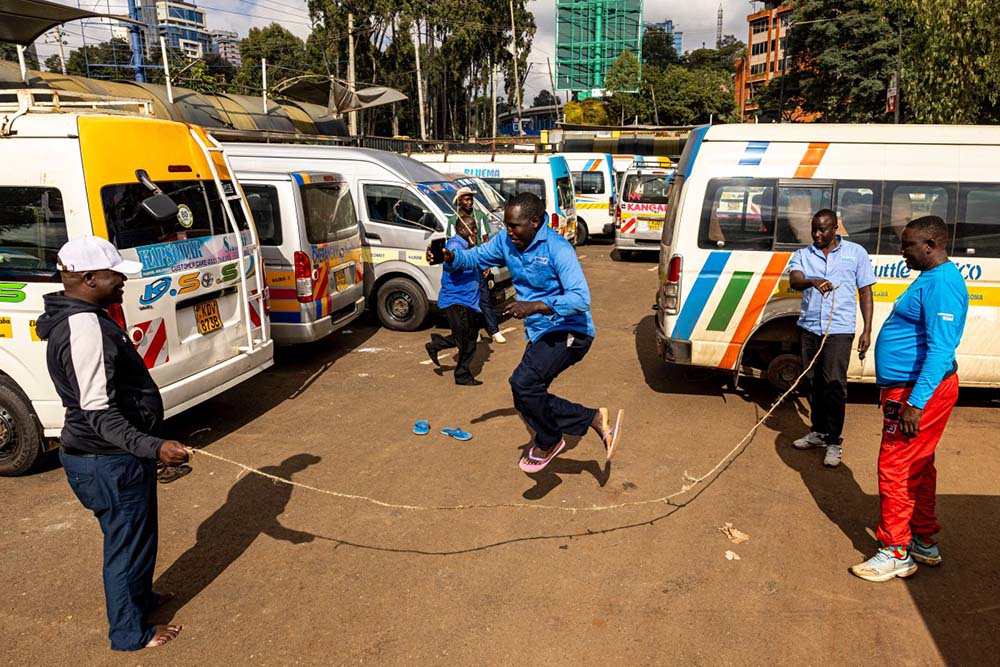 Public transport buses (locally known as matatu) crews pass the time with games amidst their grounded mini-buses due to a nationwide strike by transporters now in it's second day over fuel price hikes in Nairobi on May 19, 2026. (Credit: AFP)