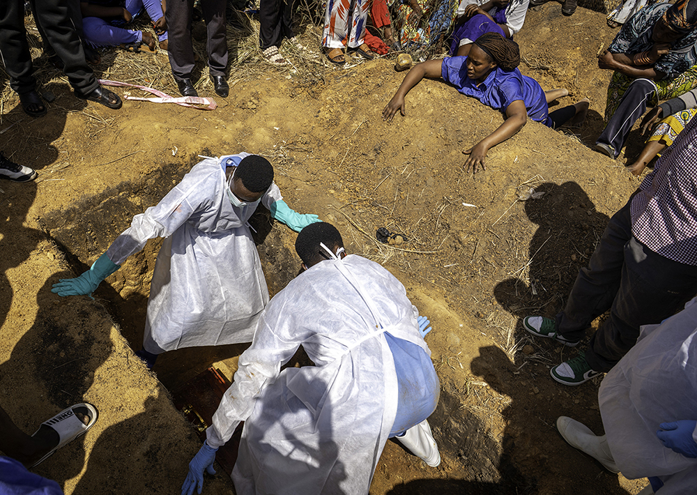 A woman (top R) reacts as a person suspected of having died from Ebola is buried in Bunia, in the eastern Democratic Republic of the Congo, on May 25, 2026. (AFP)