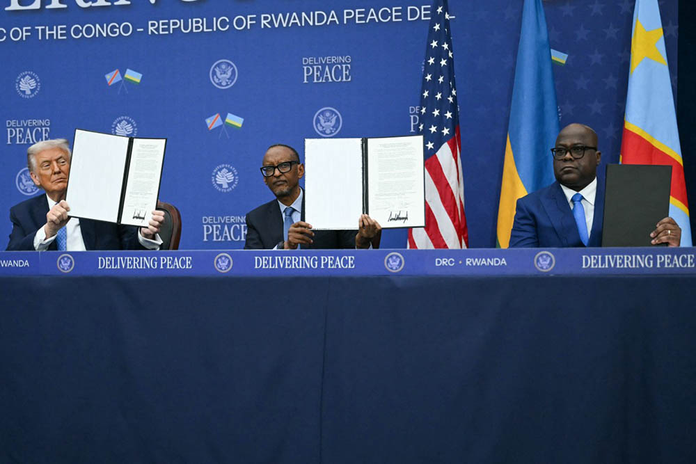 US President Donald Trump (L) participates in the signing ceremony of a peace deal with the President of Rwanda Paul Kagame (C) and the President of the Democratic Republic of the Congo Felix Tshisekedi (R) at the United States Institute of Peace in Washington, DC, on December 4, 2025. (Credit: AFP)