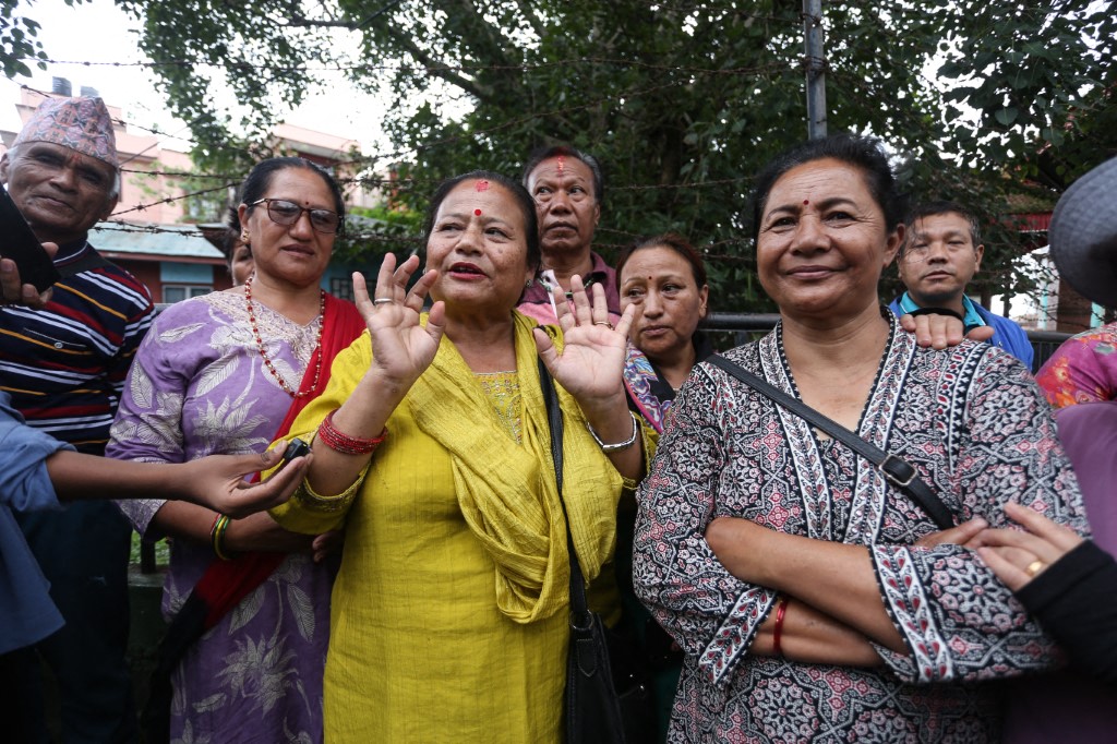Family members and relatives of two people rescued from the Trishuli 3A Tunnel, ten days since the Tibet-Nepal floods, gather outside the Military Hospital in Kathmandu on September 4, 2026.
