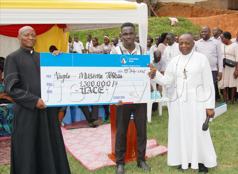 Fr. Pius Male (left) and Bro. Herman Tamale (right) handing over a dummy cheque to Joshua Musema, one of the students who performed exceptionally well in the UACE exams.