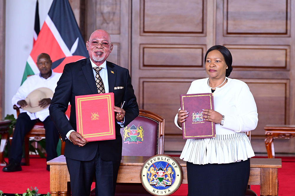 Uganda's Foreign Affairs Minister Jeje Odong and his Kenyan counterpart after signing an MOU at Nairobi State House on Wednesday. PPU Photo