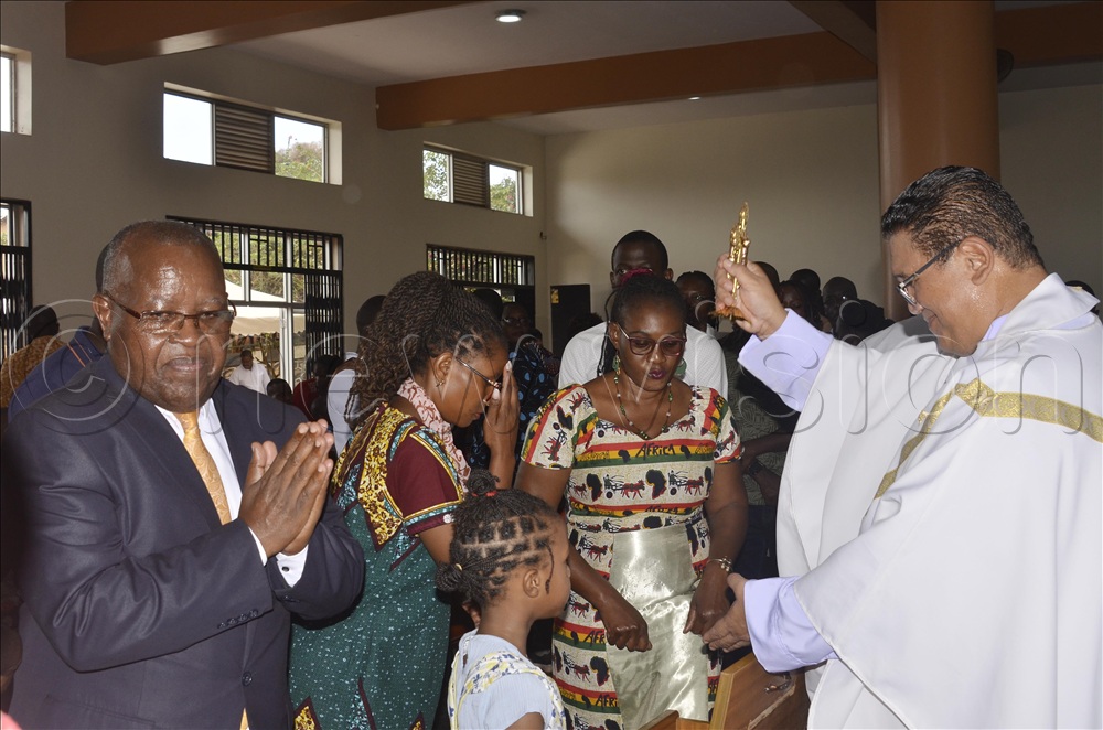 Fr Raymond Kalanzi blessing Christians in the second Mass at St Padre-Pio Catholic Parish, Kabulamuliro
