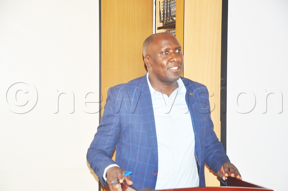 Dr John Bbaale, lectuerer at the College of Business and Management Studies, Makerere University presenting on the plans of the study during an inception meeting for the study held at the College of Business and Management Studies (COBAMS), Makerere University, Kampala. (Photo by John Odyek)