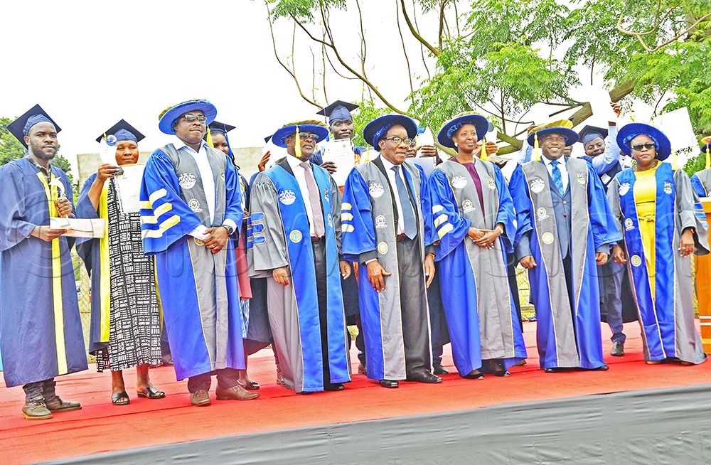 Dr Silver Mugisha, NWSC Managing Director, Engineer Badru Kiggundu, NWSC board chairman, Allen Kagina, TVET Council Chairperson, Onesmus Oyesigye, UVTAB executive secretary pose for a photo with other delegates. (Photo by Juliet Kasirye)