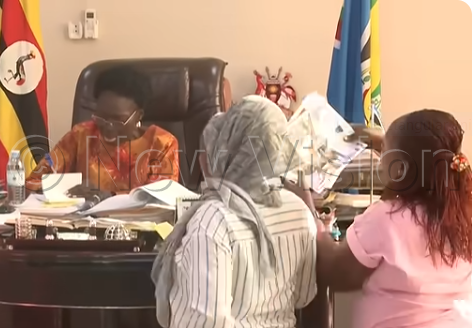 Wives of men who were trafficked to Russia present a petition to Rebecca Kadaga. (Photo by Ignatius Kamya)