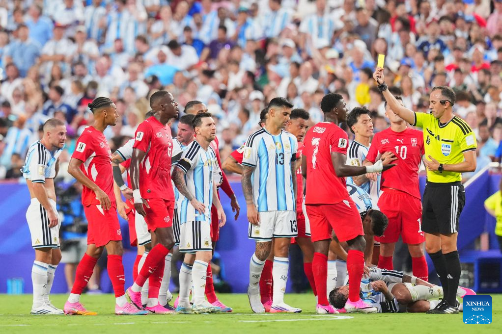 Referee Joao Pedro Silva Pinheiro (1st R) shows a yellow card to Breel Embolo of Switzerland (4th R). (Xinhua/Xu Chang)