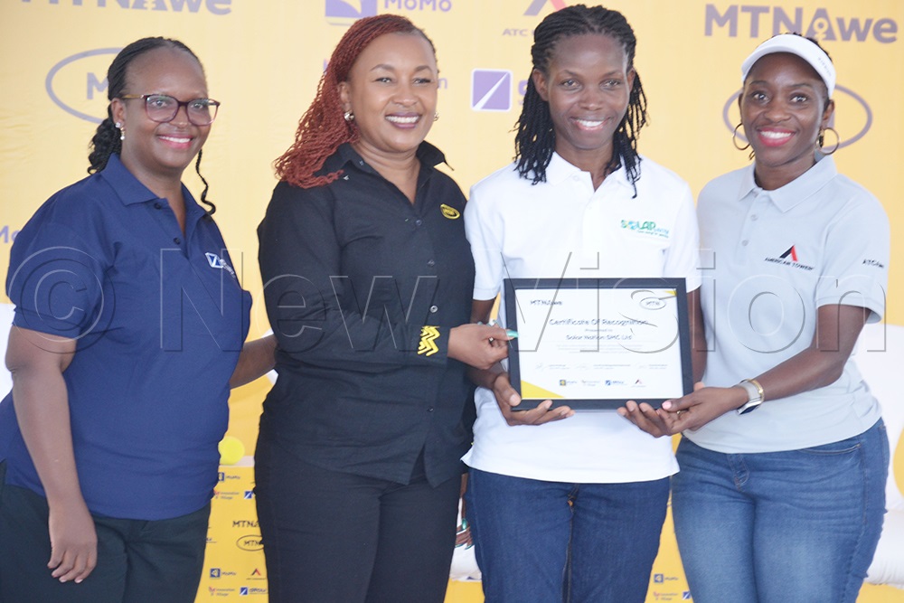 Sylvia Mulinge, the chief executive officer of MTN Uganda (second left), Dorothy Kabagambe Ssemanda, CEO ATC Uganda (extreme right) and Annette Kiconco, chief retail banking Officer DFCU bank, handing over a certificate of appreciation to Stella Lunkuse, the founder and managing director of Solar Nation Limited, for being one of the best women in business from AWE phase I cohort. (Photo by Jackson Kitara) 