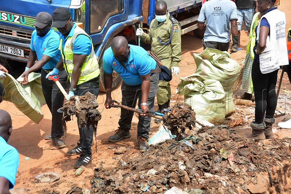 Kampala Capital City Authority workers conduct a cleaning exercise along Kalungi Bridge Road at Kironde Zone, Sembule B in Rubaga Division, Kampala on December 6, 2025. (Photo by Francis Emorut)