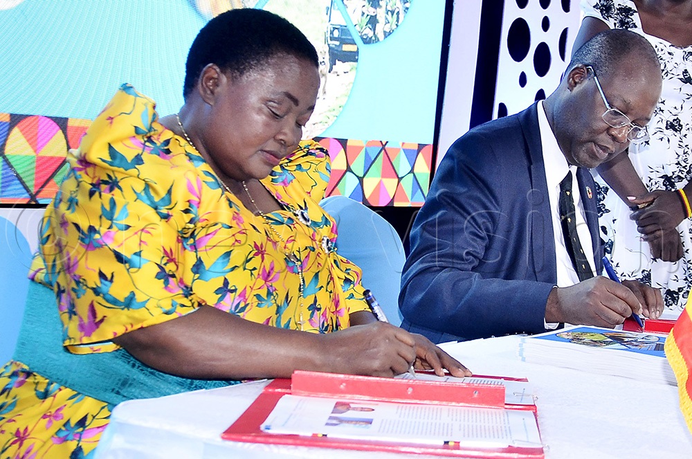 Prime Minister Robinah Nabbanja (left) and the UN Resident Coordinator in Uganda, Leonard Zulu sign an agreement during the United Nation 80th anniversary and the launch of UN Uganda sustainable development cooperation framework 2026 to 2030. (Photo by Ronnie Kijjambu)