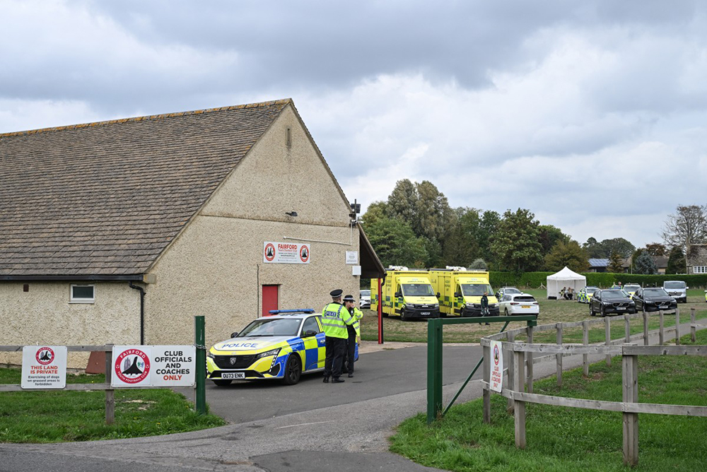 Police stand at the entrance at a base set up at the Fairford Youth Football Club near RAF Fairford base, south-west England on September 27, 2026, as UK counter-terrorism police investigate an incident near the base in the village of Whelford.