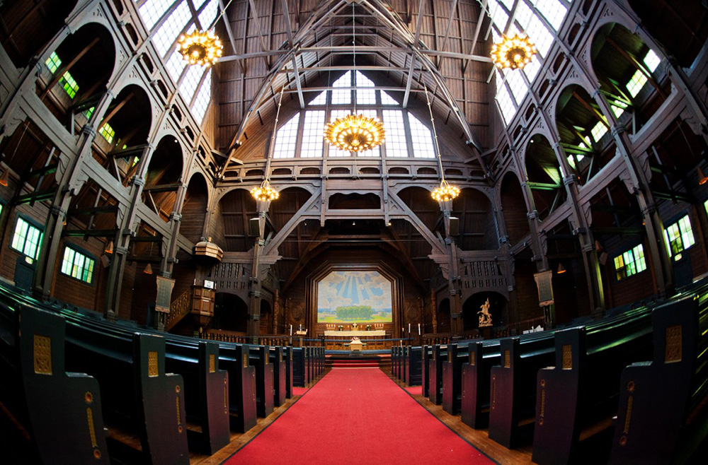 This picture taken with a fisheye lens on November 5, 2013 shows the interior of the church in Sweden's northernmost town of Kiruna. The town centre will be moved a few kilometers (miles) away to save it from sinking into the ground due to underground cracks created by iron ore mining. (Photo by Jonathan NACKSTRAND / AFP)