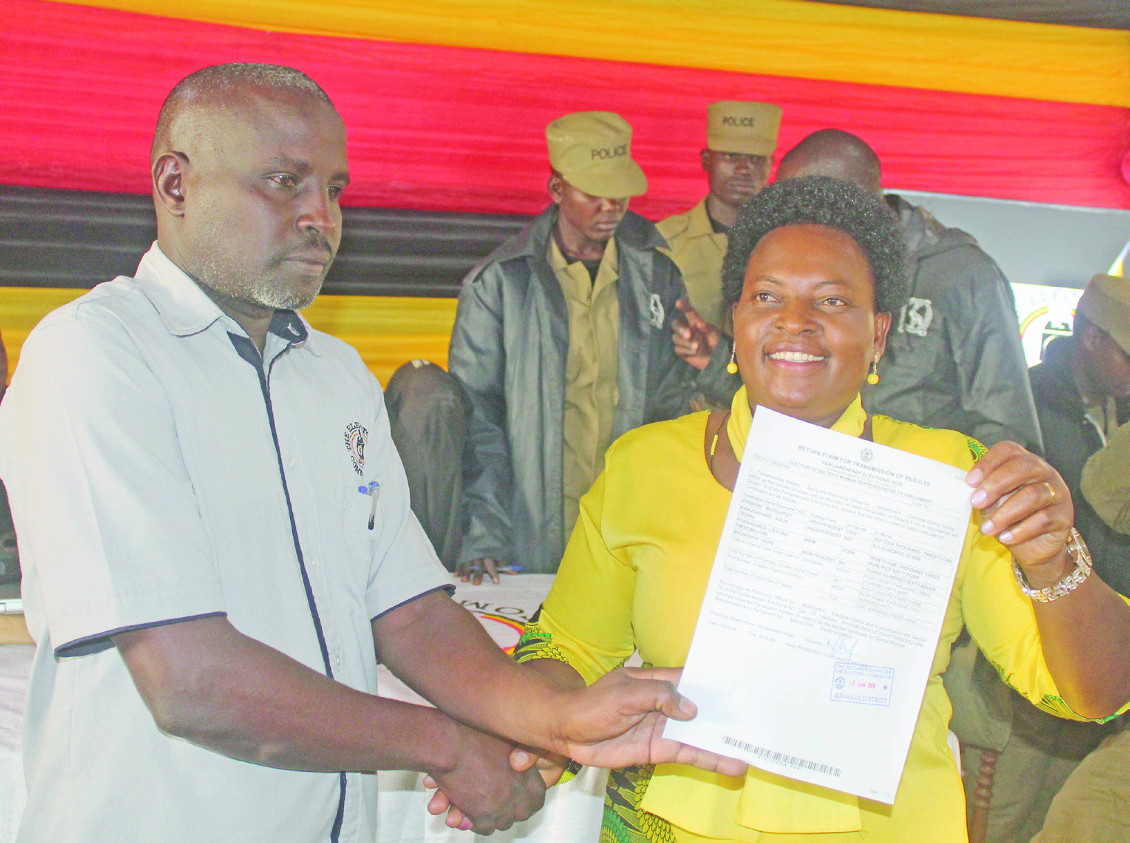 Loyda Kyarikunda Twinomujuni (right), the winner of Mbarara district woman MP race, receiving a declaration form from Mbarara district returning officer William Twinamatsiko. (File)