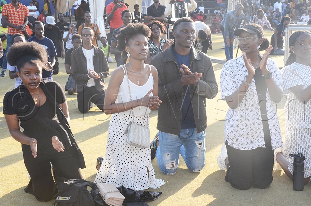 Worship House church members kneeling while praying during the crusade at Hockey Grounds, Lugogo in Kampala on May 20, 2026. (Photo by Isaac Nuwagaba)