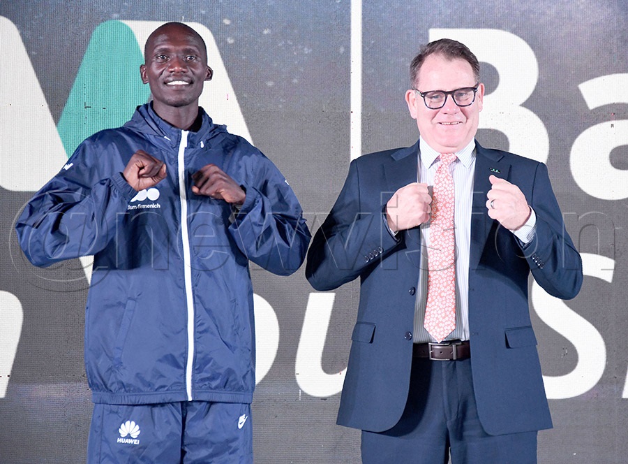 I&M Bank CEO Robin Bairstow (right) pose with Joshua Cheptegei at the launch of their three-year partnership. Photo by Michael Nsubuga