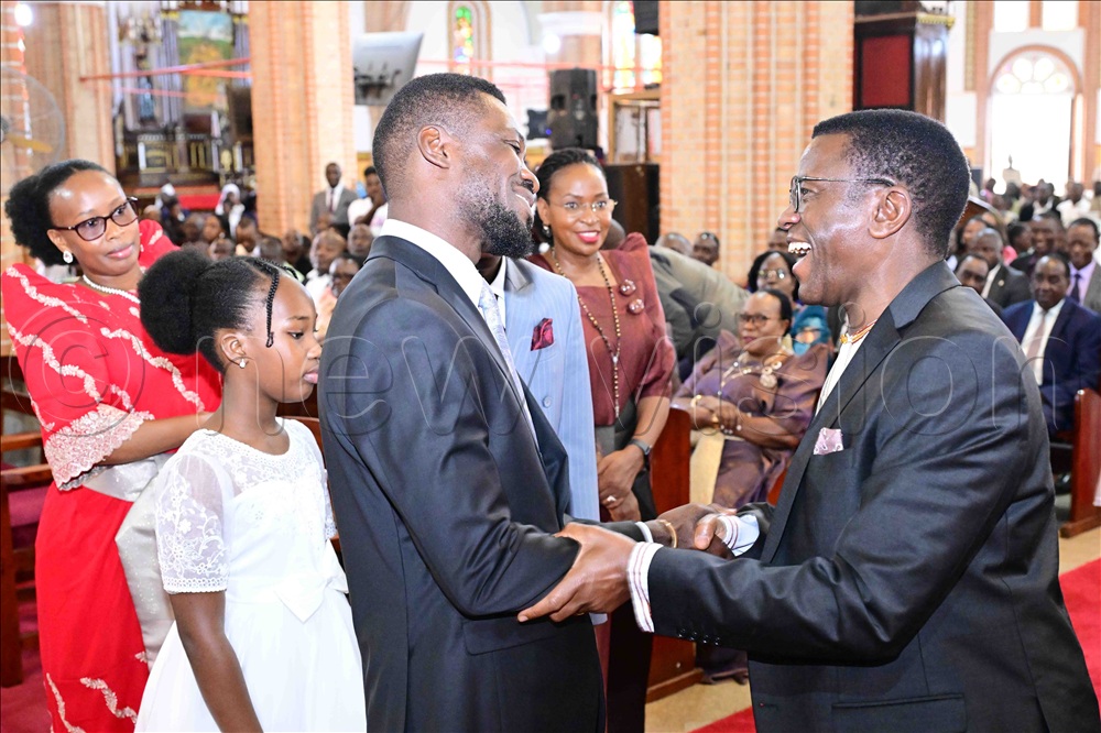 NUP presidential Candidate Robert Kyagulanyi Ssentamu (3rd left) shaing a light moment with the Katikkiro of Buganda Charles Peter Mayiga (right) before commencement of the Christmas prayers at Lubaga Cathedral on Thursday 25th December 2025. Kyagulanyi was in the company of his wife Barbie (left) and two of their children. 