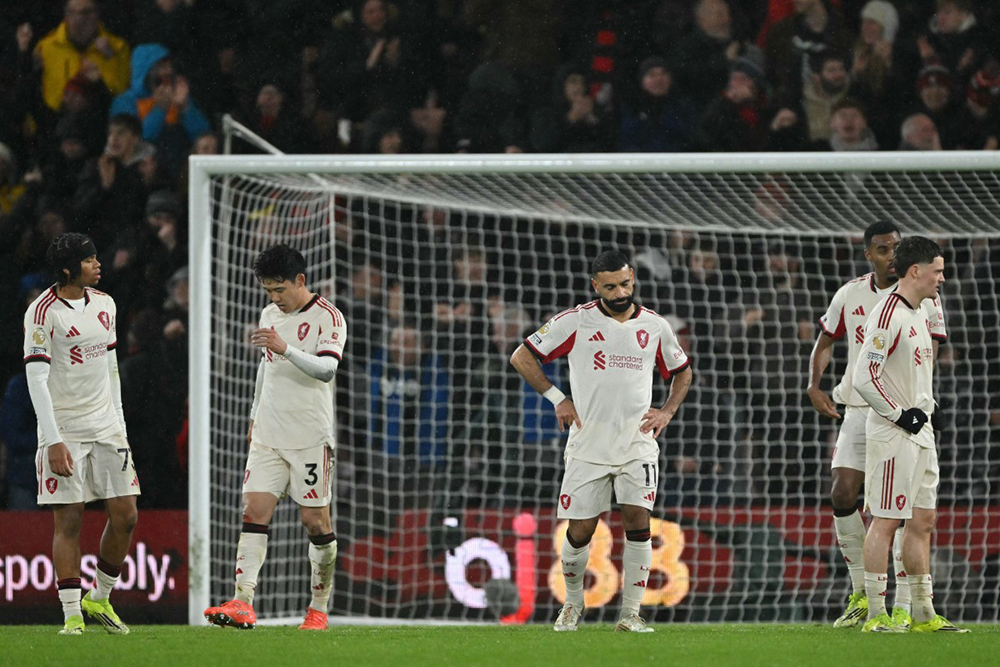 Liverpool's Egyptian striker #11 Mohamed Salah (C) and teammates react to conceding late on in the English Premier League football match between Bournemouth and Liverpool at the Vitality Stadium in Bournemouth, southern England on January 24, 2026. 