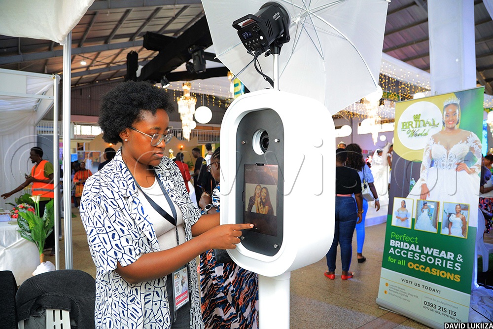 Patience Ankunda, Chief Executive Officer of The Avenoir Experience operating their new machine at the Avenour Experience studio during the Bride and Groom Expo. (Photo By David Lukiiza)