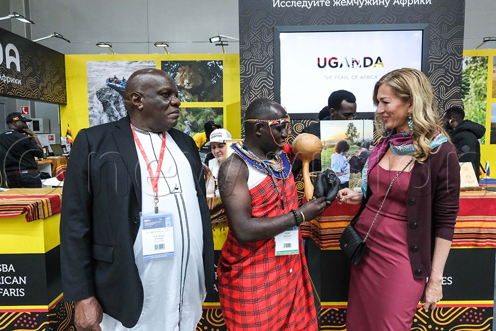 Joseph Aliganyira (C) (tour operator) talking to Maria Badakh (right) Sales Director MITT as Ambassador Moses Kizige, Uganda's envoy to Russia (left) looks on during the Moscow International Travel and Tourism (MITT) Expo in Moscow, on March 12 2026. (Photo by Hajarah Nalwadda)