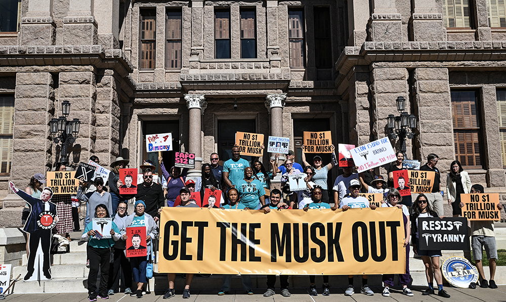 People protest during the "No $1 Trillion for Elon Musk!" rally, at the Texas State Capitol, in Austin, on November 5, 2025. (AFP)