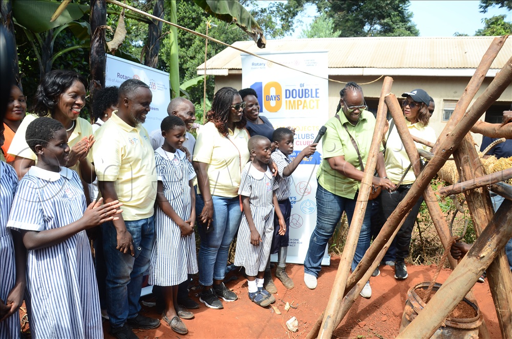 Angella Ssemukuutu (in green top extreme Right), the Guest of honour and past assistant governor inspecting the construction of the underground well which part of the Water, Sanitation and Hygiene project at St. Bruno Zziru Primary school as Rotarians, teachers and pupils look on. This was during the event at the school in Ssisa subcounty, Wakiso district on July 25, 2026. 