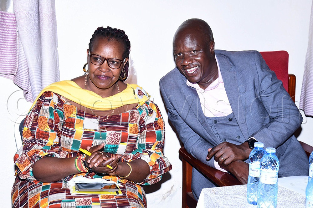 Josephine Omara, the RDC Ngora district sharing with the LC5 Ngora James Robert Otim after being sworn in. (Photo by Godfrey Ojore)