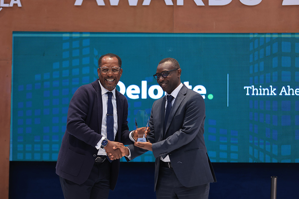 Richard Byarugaba hands Ronald Makata, CFO Stanbic, the Compliance & Governance Award. Makata also bagged the Finance Transformation & Technology Award. (Courtesy photo)