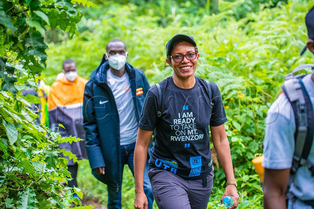Lilly Ajarova, the Chief Executive Officer for Uganda Tourism Board accompanied by world athletics champion Joshua Cheptegei while hiking Rwenzori mountains. (Julius Luwemba/File)