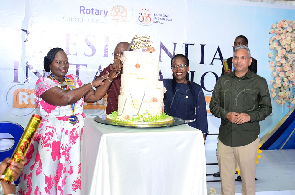 (L-R) Clare Nakabonge Byekwaso the new president of the Rotary Club of Lubowa, Past District Governor District 9213 Francis Xavier Sentamu, Deborah Atwiine the Club Assistant Governor and Rotarian Ajay Kumar Pal (in green shirt) the Chief Executive Officer of Quality Chemical Industries Limited (QCIL) cut cake to celebrate the Byekwaso’s installation as the club president. This was during her installation at Orion gardens Lweza on May 16, 2026. (Credit: Lawrence Mulondo)
