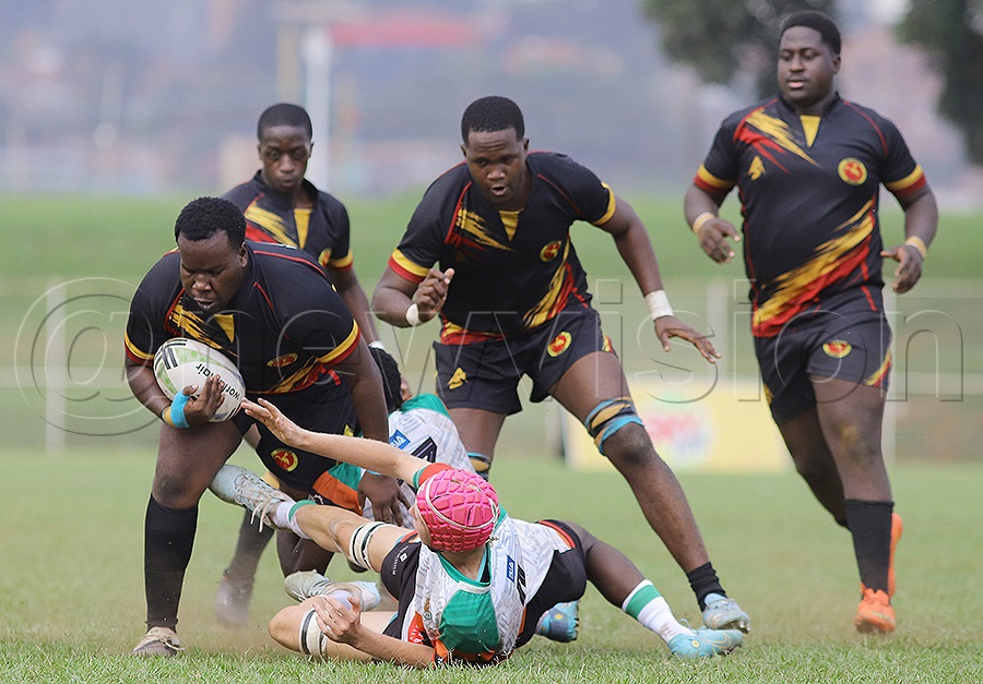 A Ugandan player shoves off a Zambian opponent during the Africa U20 Barthes Cup Division One final at Muteesa II Memorial Stadium, Wankulukuku, on Tuesday. Photo: Johnson Were