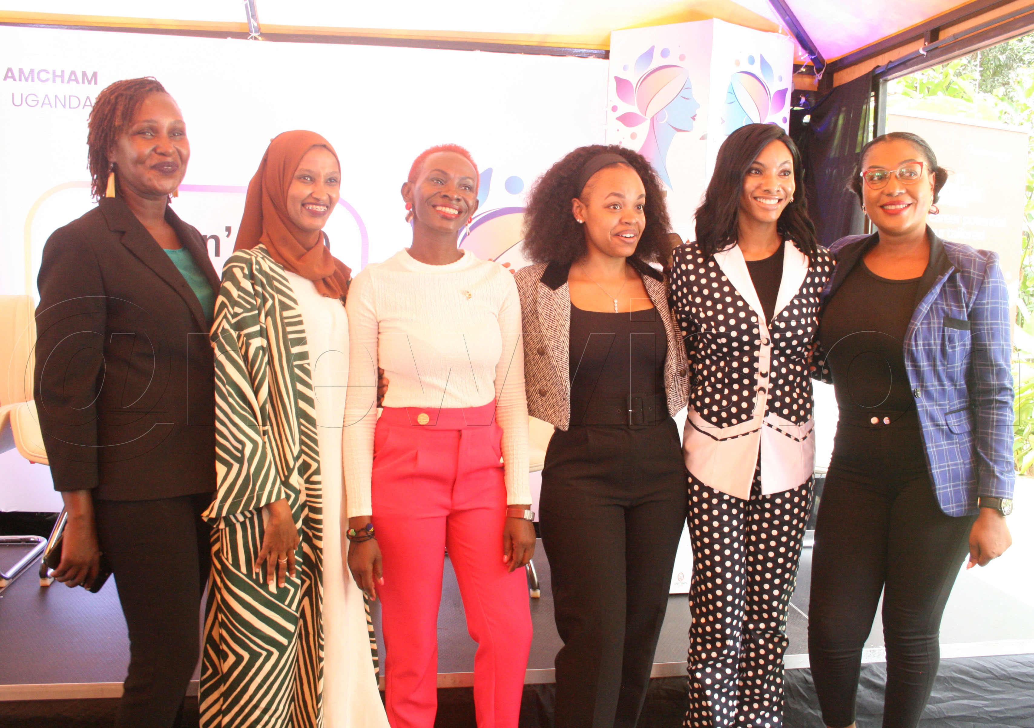 Eve Zalwango (in pink) the General Manager of AMCHAM with some members at the forum. Photo by Maureen Nakatudde