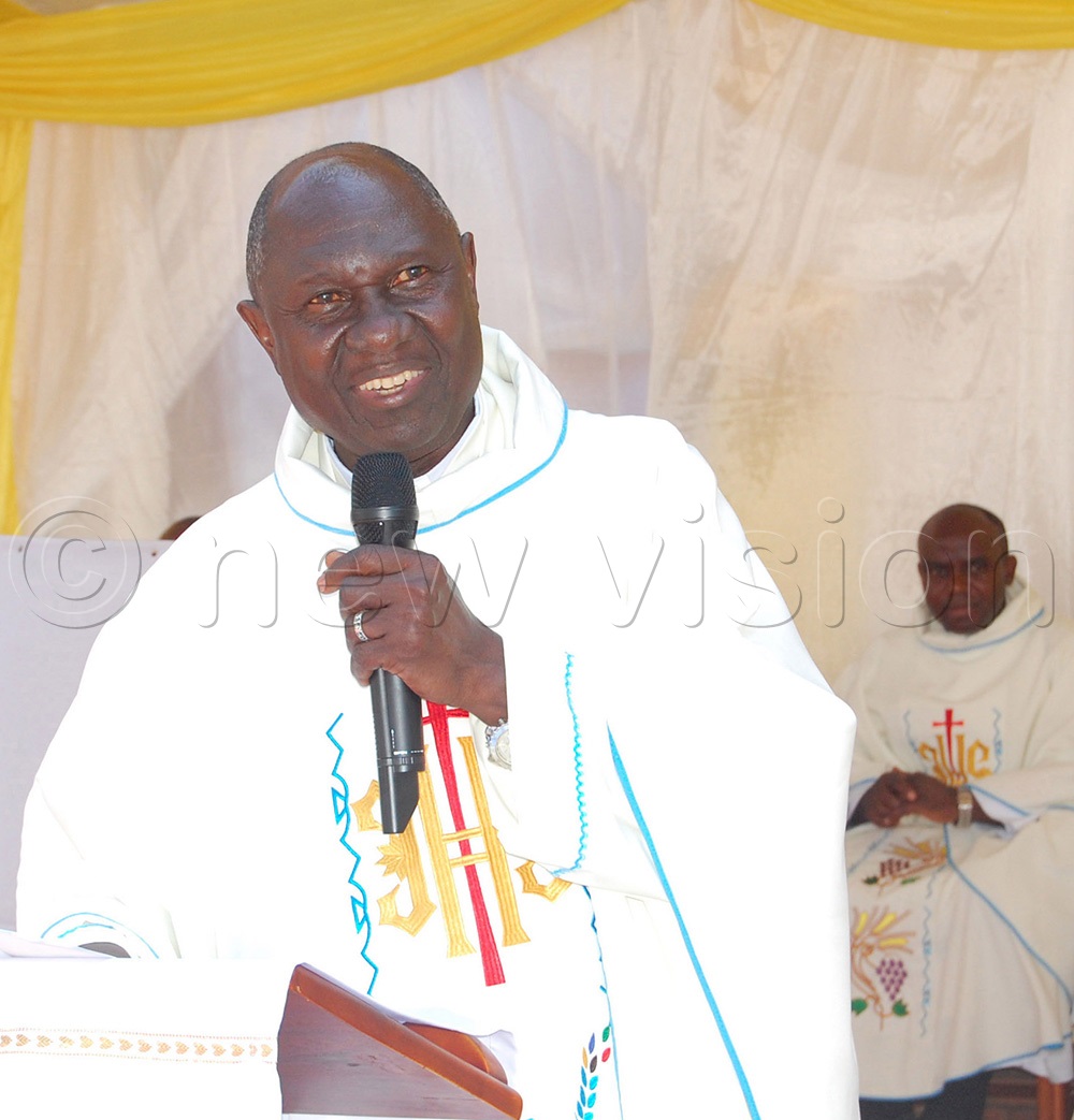 The main celebrant, Msgr. Dr. Larry Ssemusu delivers his homily during mass. (Photo by Mathias Mazinga)