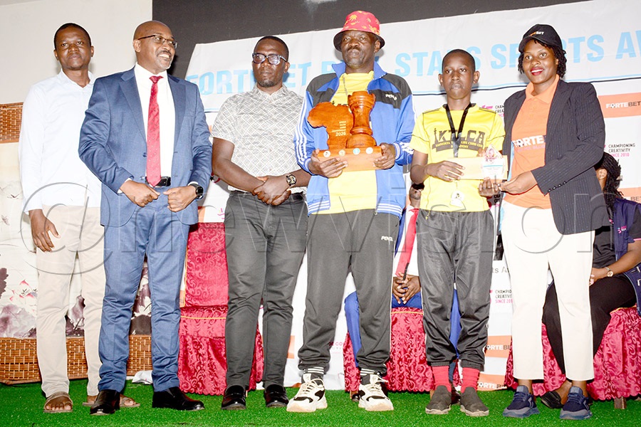 Real Awards winner Alvin Muhirwa (2nd right) poses with a delegation from the UCF led by president Andrew Bakiza (2nd left), coach Patrick Mukasa (3rd right) and Fortebet's Resty Mbatidde (right) at Nanjing Restaurant, June 2, 2026. Photo by Michael Nsubuga.