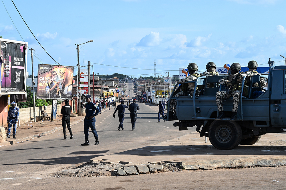 Ivorian gendarmes and soldiers patrol while waiting for the arrival of the Ivorian President and presidential candidate of the Rally of Houphouëtists for Democracy and Peace (RHDP), Alassane Ouattara, on the eve of his first presidential campaign rally in Daloa on October 10, 2025. (AFP)