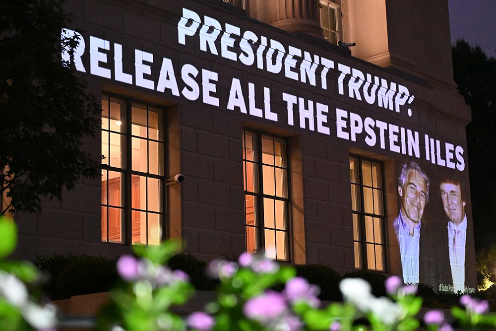 A message calling on President Donald Trump to release all files related to Jeffrey Epstein is projected onto the US Chamber of Commerce building across from the White House in Washington, DC, on July 18, 2025. (AFP)