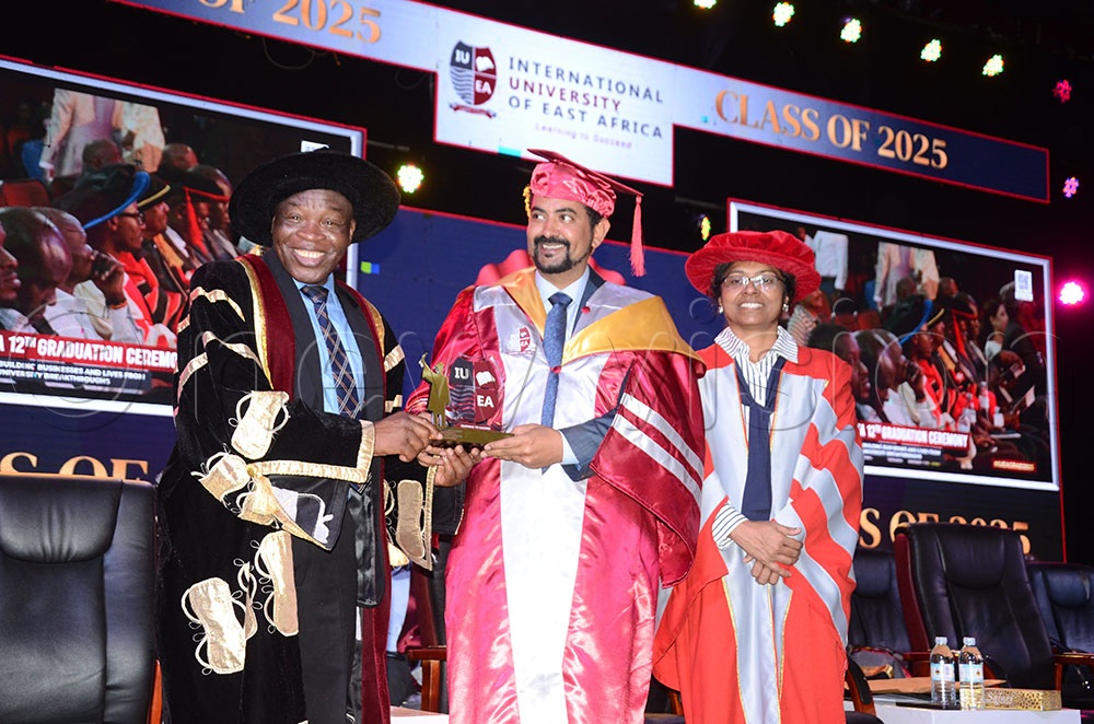 Akaezuwa (left) handing Alwi the Exceptional Leadership Award. On the right is Bhabuu.