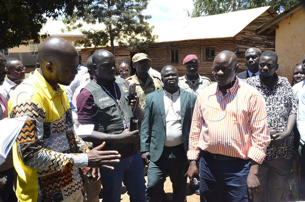 Minister Balaam listens to Rogers Amanyire, the Mayor of Masindi Municipality. (Photo: Yosam Gucwaki)