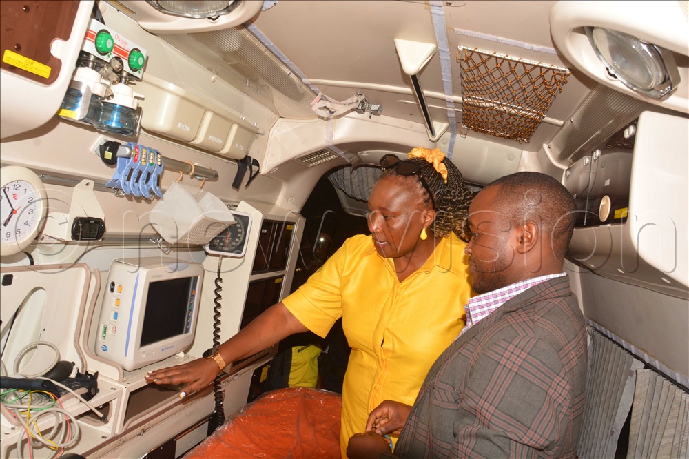 The senior presidential advisor on agriculture and rural development Peace Rugambwa (left) shows the fully equipped interior of the ambulance worth sh180m donated by President Yoweri Museveni to clinical officer of Bwambara Health Centre III Francis Muhumuza during the handover ceremony at Bwambara grounds in Rukungiri district on Saturday November 15, 2025.