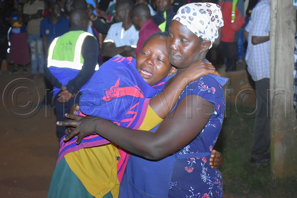 A crying mother claimed that three of her children remained trapped under the rubble. (Credit: Julius Luwemba)