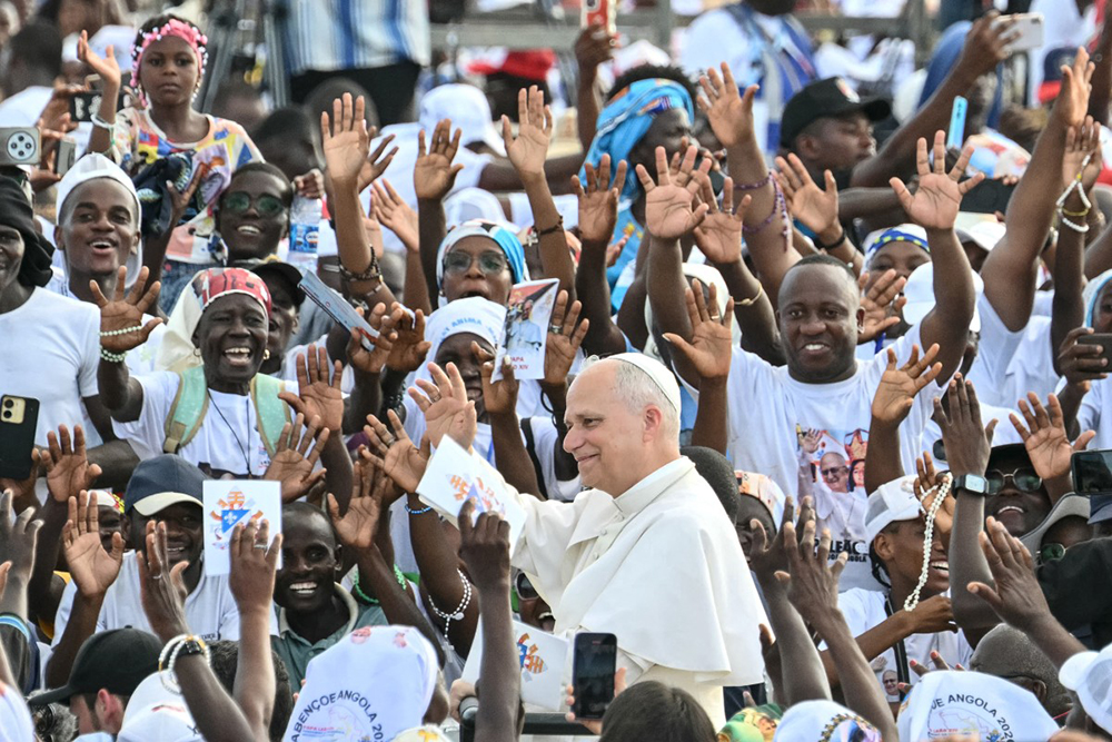 Pope Leo XIV (C) waves to the crowd as he arrives to lead a Holy Rosary Prayer on the esplanade in front of the "Mama Muxima" Shrine in Muxima on the seventh day of an 11-day apostolic journey to Africa, on April 19, 2026.
