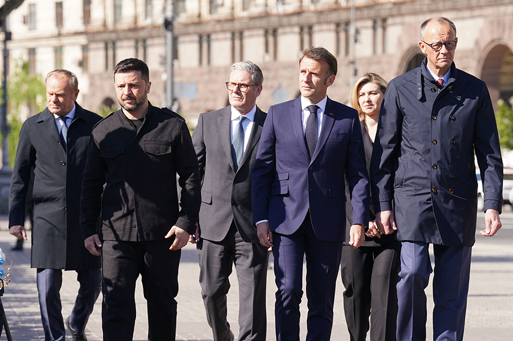 (From L) Poland's Prime Minister Donald Tusk, Ukraine's President Volodymyr Zelensky, Britain's Prime Minister Keir Starmer, France's President Emmanuel Macron, Olena Zelenska and Germany's Chancellor Friedrich Merz pay their respects to the victims of war at the Memorial for the Fallen at the Independence Square (Maidan) in Kyiv on May 10, 2025, ahead of a gathering of European leaders in the Ukranian capital. (AFP)