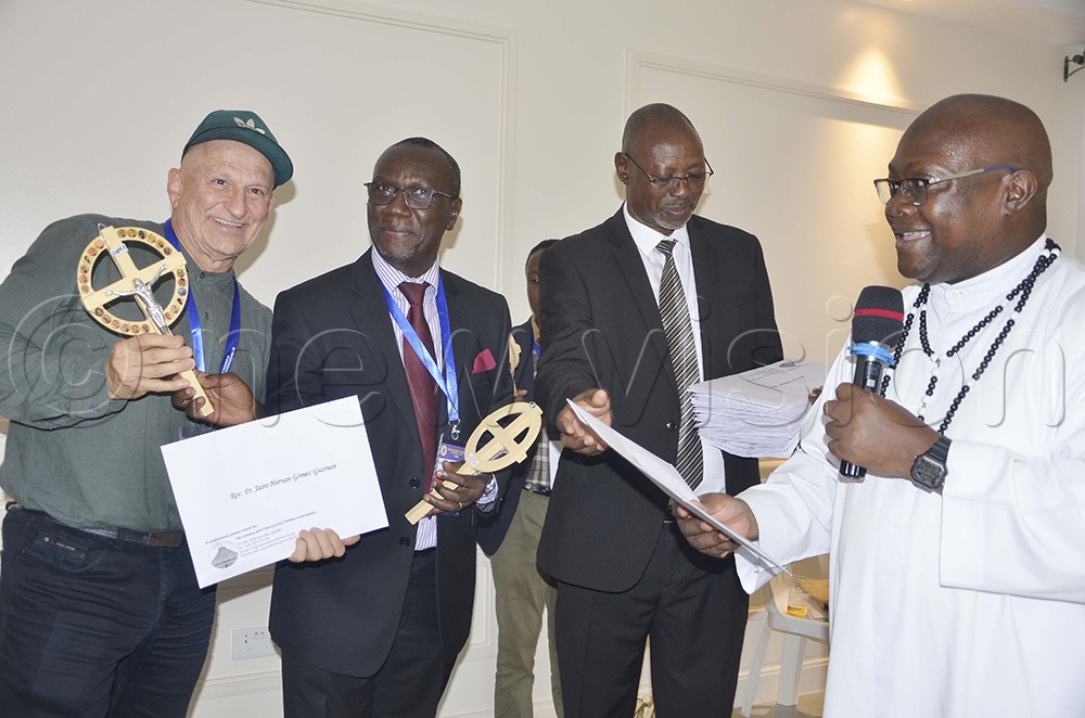  Uganda Martyrs Shrine led by Rector, Fr Vincent Lubega (in white cassock) gives the delegates gifts. (Photo by Juliet Anna Lukwago)