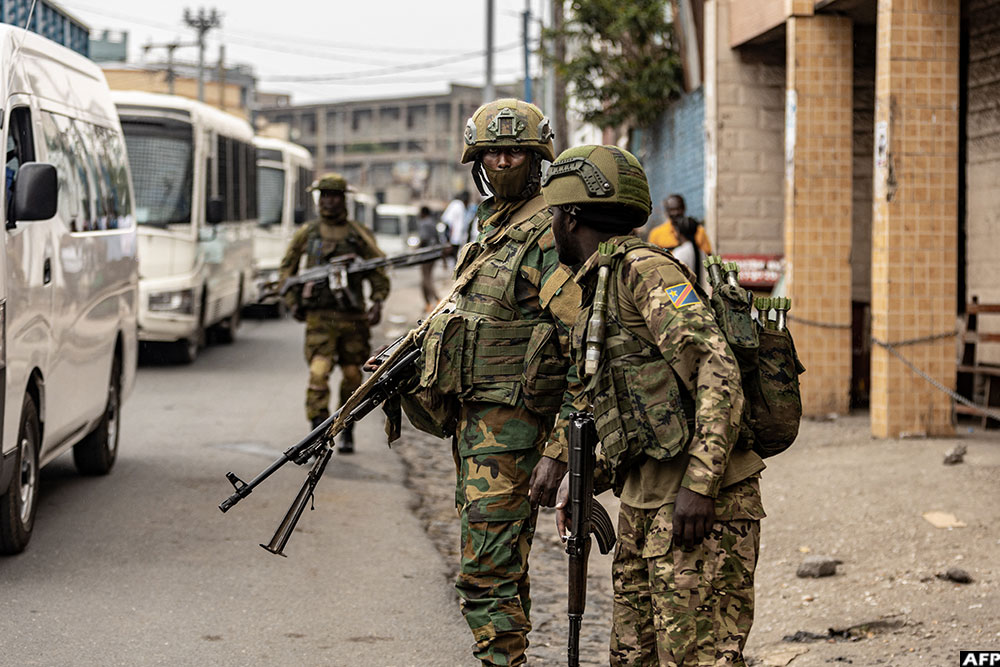 Members of the M23 armed group monitor access to the border crossing into Rwanda while conducting security inspections of vehicles in Goma on January 29, 2025.
