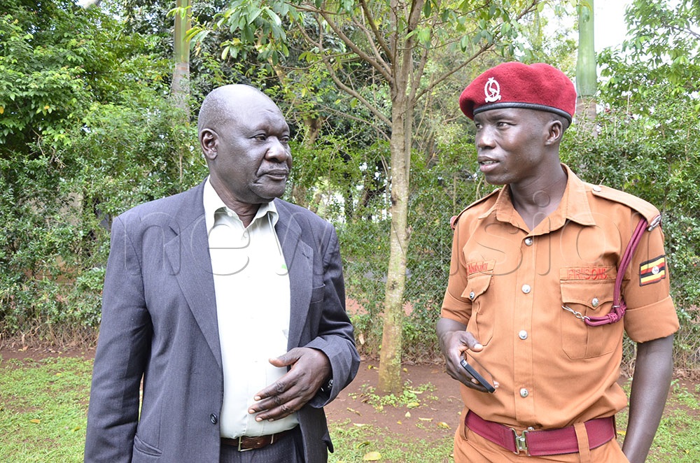 Silas Akuma late Dr Jino Abiriga's elder brother chating with Arubaku Abiriga's first son. (Photo by Yosam Gucwaki)