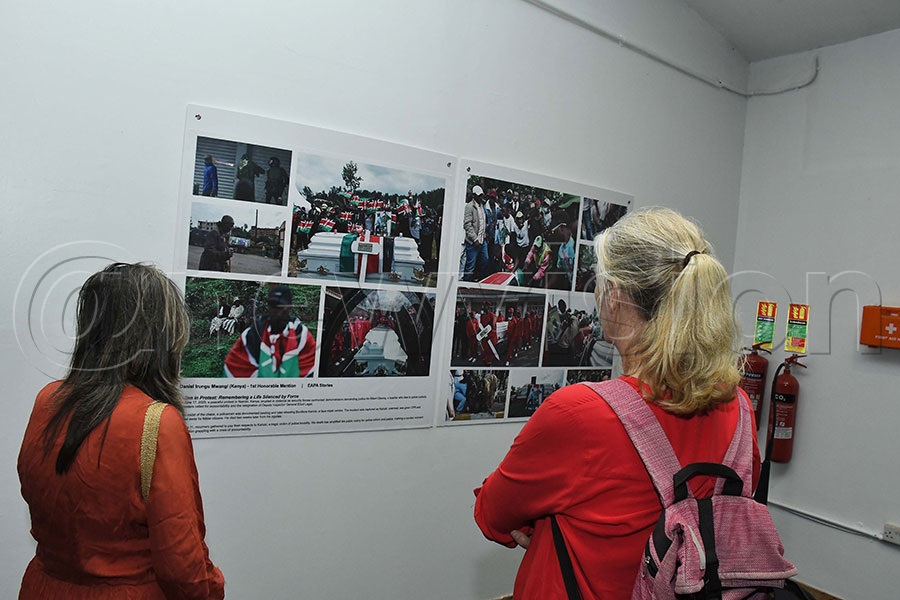 Guests looking at the incredible photos took by Kenya's Daniel Irunga Mwangi. Photo by Ignatius Kamya