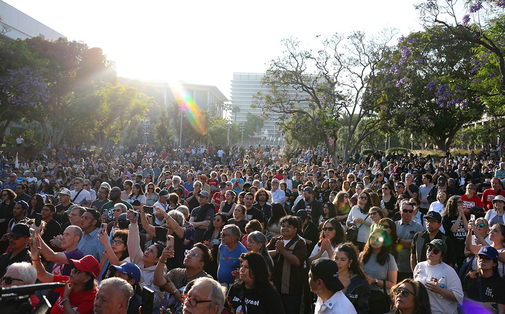 People attend a prayer vigil in Grand Park as curfew goes in effect after days of protests in response to federal immigration operations in Los Angeles on June 10, 2025.