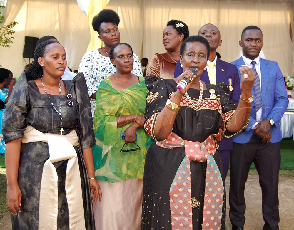 Hon. Amelia Kyambadde (holding a microphone) delivers her message. (Photo by Mathias Mazinga)