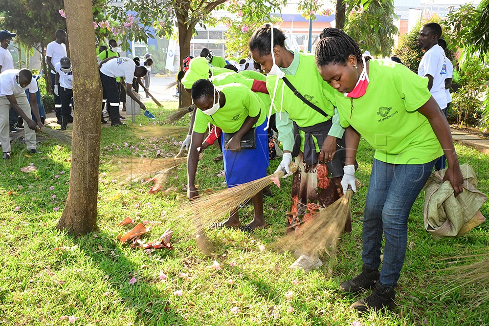 Fine Spinners employees take part in a clean-up exercise at Uganda Baati during Uganda's National Cleaning Day. (Credit: Eddie Ssejjoba)