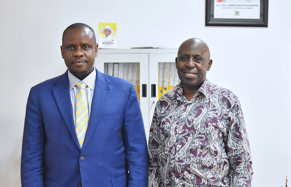Local government minister Balaam Barugahara (left) poses for a photo with State House Anti-Corruption Unit (SHACU) head, Brig. Gen. Henry Isoke (right). (Courtesy)